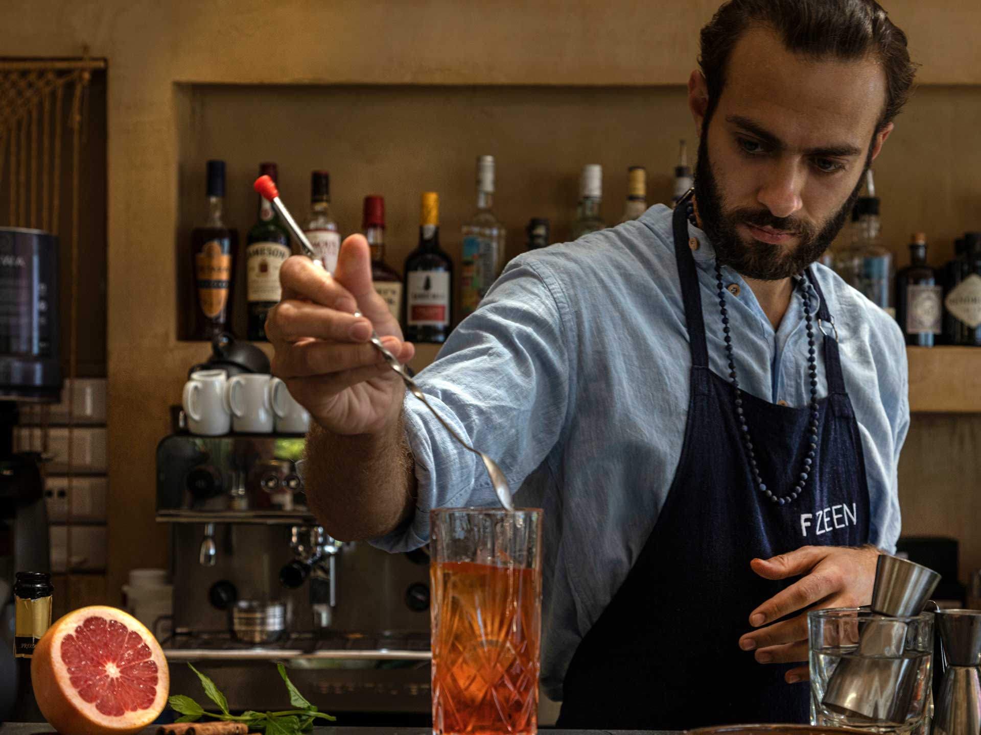 a bartender mixing a cocktail a wellness retreat's bar