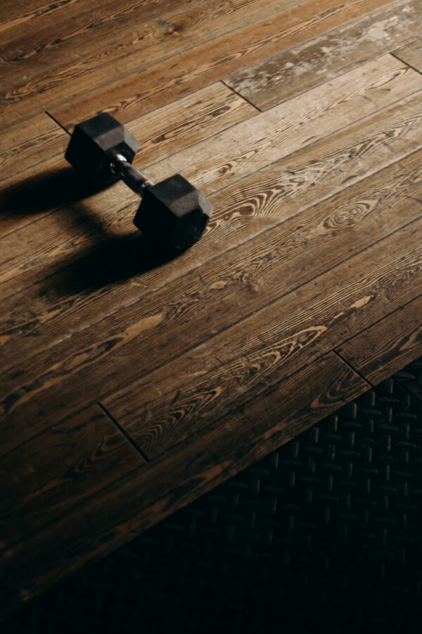 dumbbell on wooden floor of a fitness retreat in Greece