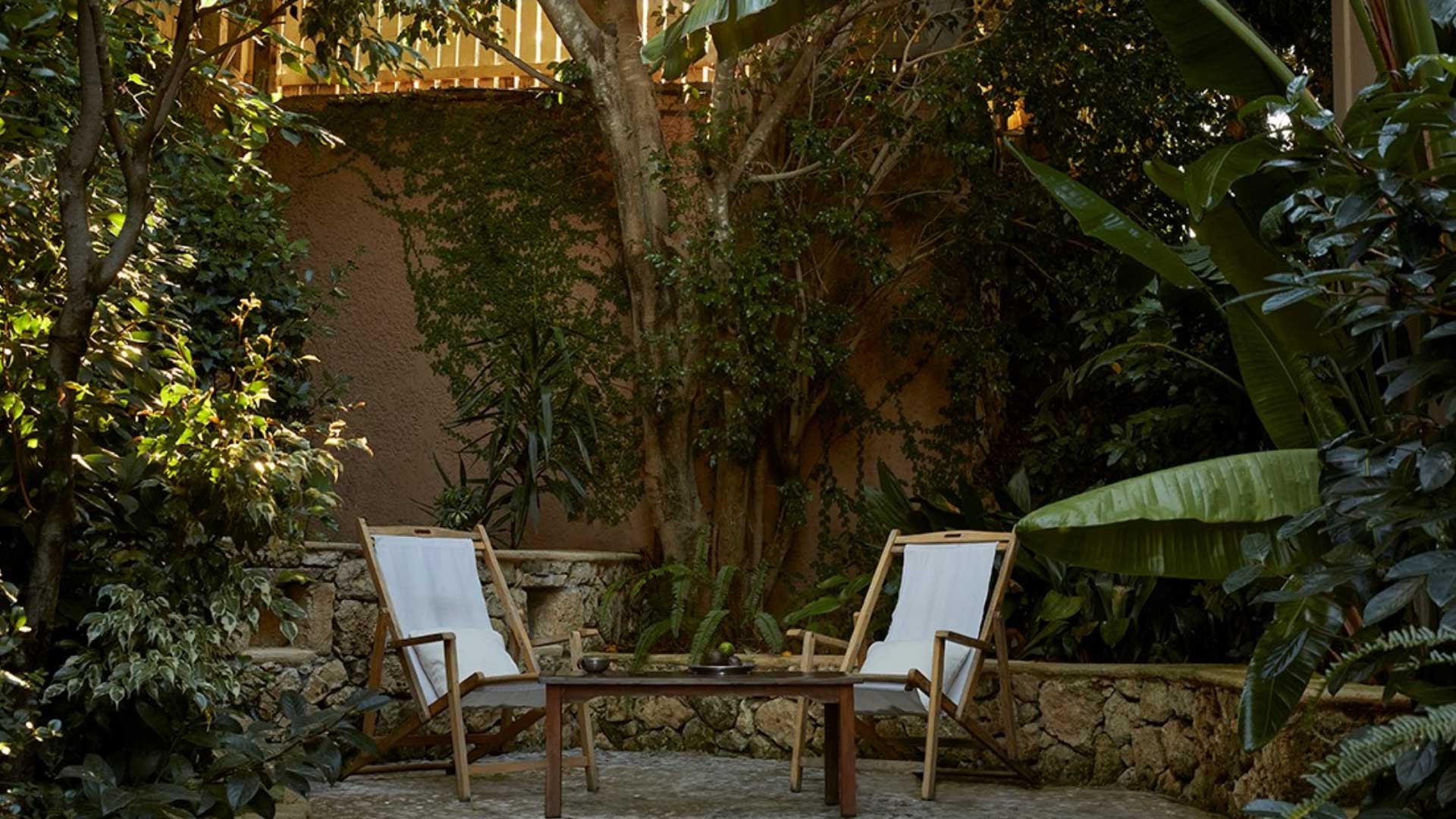 a yard with two chairs at a boutique hotel in greece