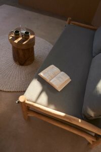 closeup of open book on lounge chair alongside coffee table