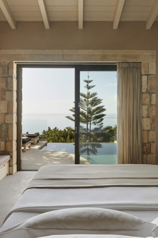 bed of a suite in Kefalonia with pool view