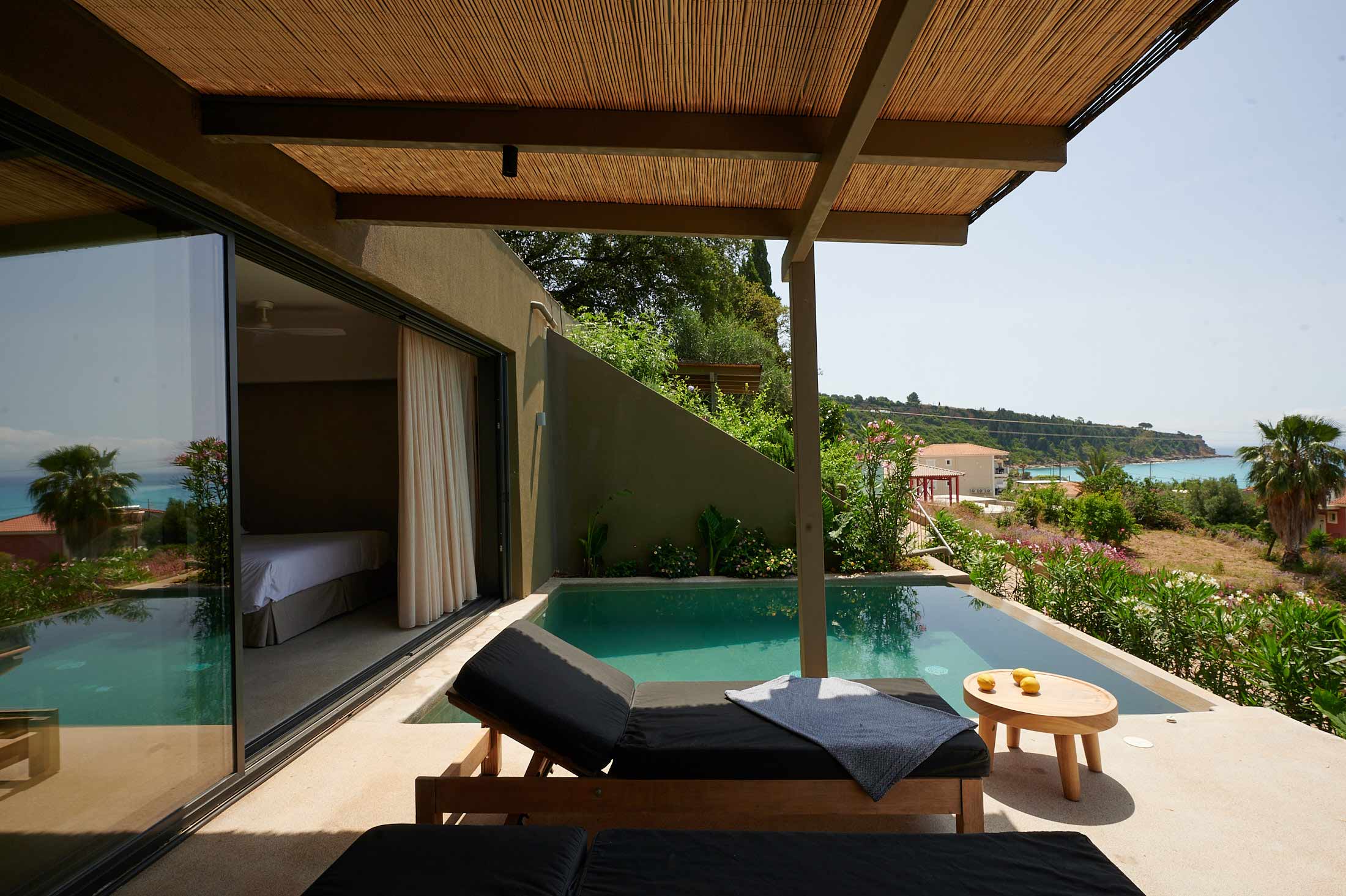 outside view of private pool with sunbed and coffee table