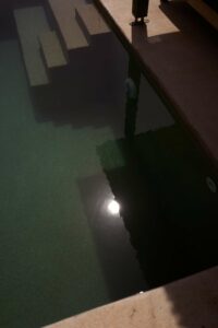 sun reflecting on surface of private pool