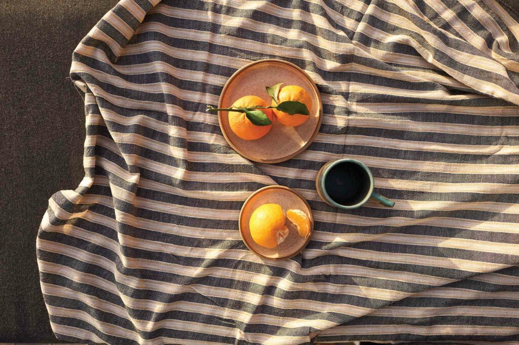 Closeup of oranges and cup of coffee F ZEEN KEFALONIA