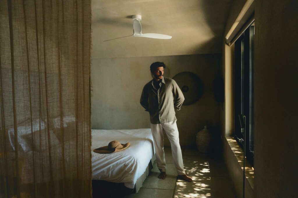 man in elegant clothing in lucurious hotel room