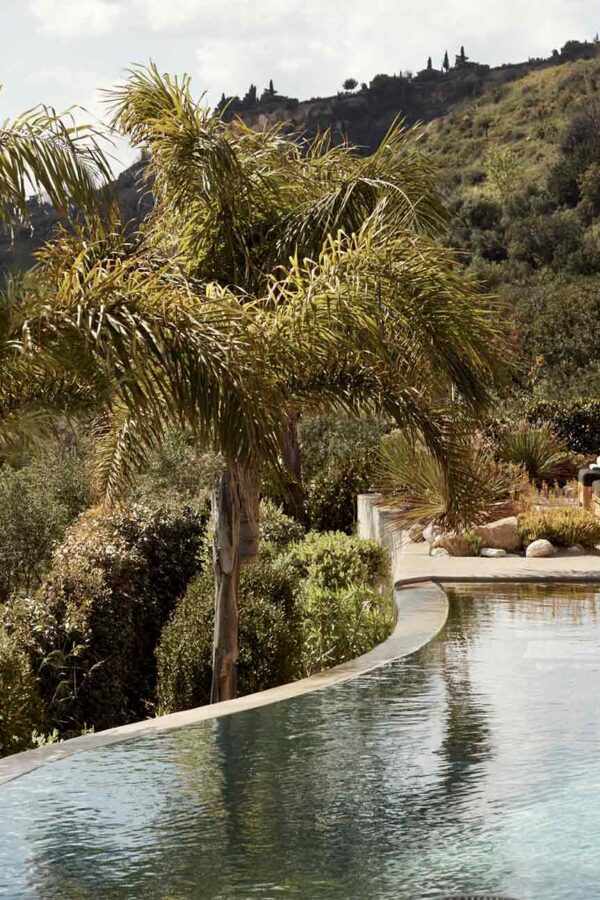 Swimming pool with sea view and green schenery